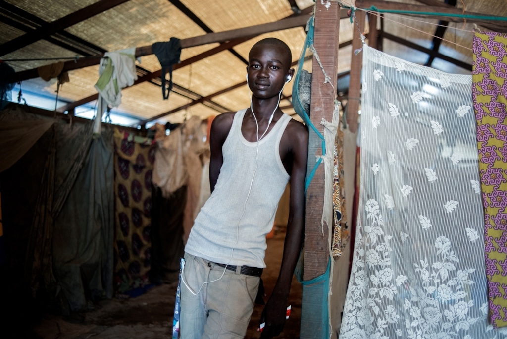 MSF159640<br/>Portrait of 20 year old Jordy at a displaced persons camp in Benzvi, Bangui.<br/><br/>Jordy comes from Bossangoa. Together with some friends, he fled the violence to find refuge in BenZvi camp, after one week on the road.<br/><br/>He survives thanks to the help of families who live in the same shelter as he does. The rest of his family is still in Bossangoa and he would like to return but cannot do so due to a lack of money.