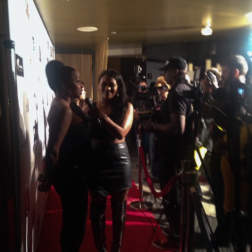 On the red carpet facing the press.