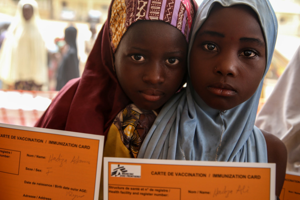 Two girls hold their MSF vaccination cards in Damaturu town, in the north-eastern Nigerian state of Yobe. Photographer: Igor Barbero/MSF