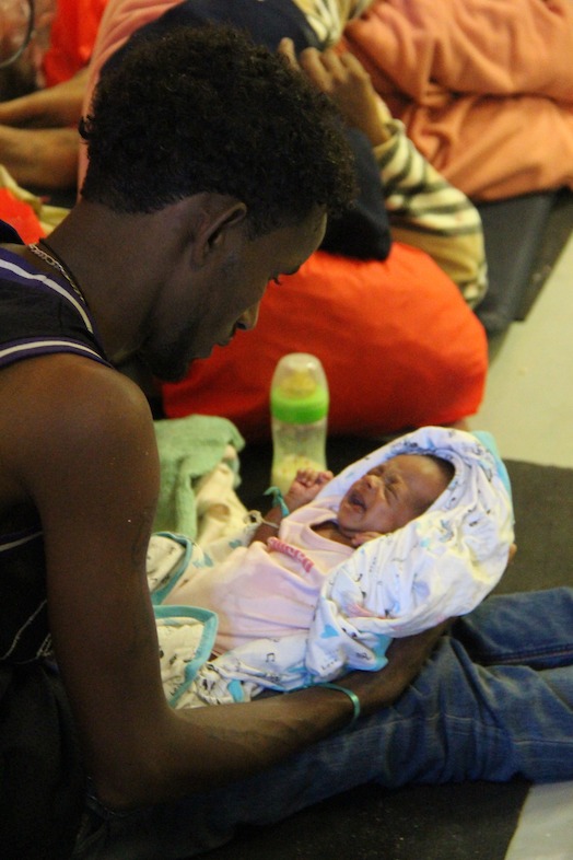 A single father holding his 1 week old baby; attempting the journey after his wife recently passed away. Photo: MSF