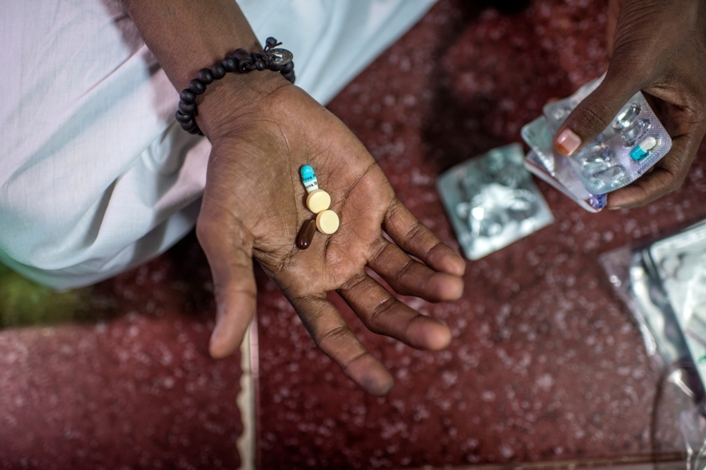 XDR-TB patient Hanif, taking his daily TB medication at home in the Govandi area of Mumbai.<br/><br/>Hanif is 25 years old, lives in Mumbai, and is one of only a handful of extensively drug-resistant TB (XDR-TB) patients in India lucky enough to be able to have acesss to the new drugs. After having failed treatment for the fourth time, Hanif was referred to the clinic of Medecins Sans Frontieres (MSF) / Doctors Without Borders, an international medical humanitarian organisation who since 2006 provides free diagnosis, treatment and support to patients with drug-resistant TB in Mumbai. Photographer: Atul Loke/Panos Pictures