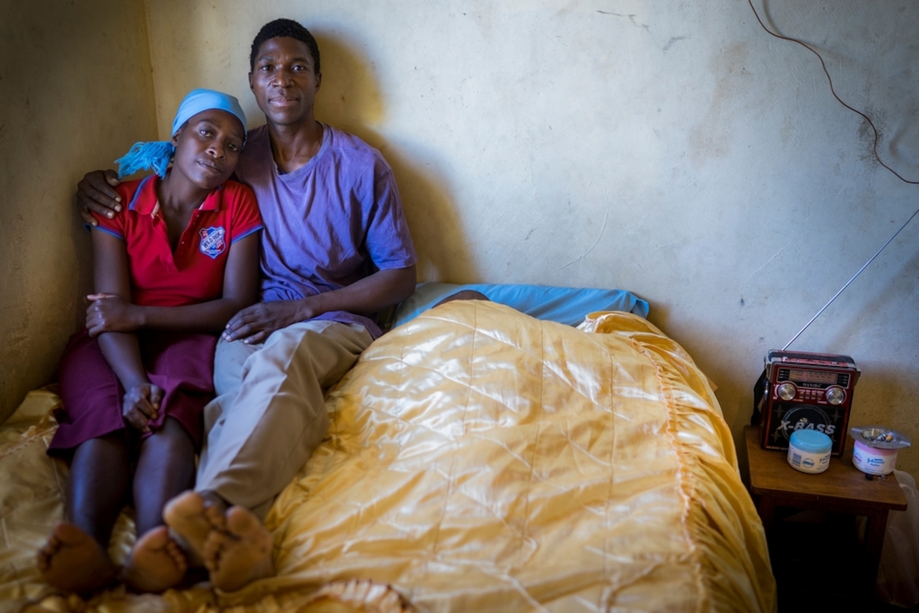 Portrait of Ngonidzashe (28) and her husband Hastings at home. They are a HIV positive couple supporting each other through ARV treatment, they also have 3 healthy children. © Melanie Wenger