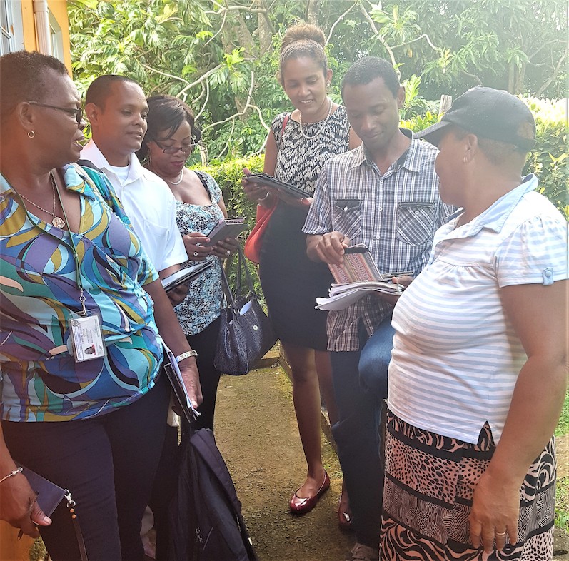 OECS Statistical Services Unit (SSU) and St. Lucia's Central Statistical Office (CSO) staff members conducting a survey with the use of tablets.