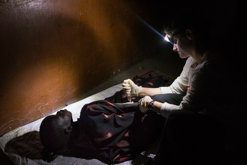 An MSF staff member monitors a boy with suspected rabies after he was bitten in the head by a dog. Forced to evacuate Leer hospital after it was attacked by armed men, the MSF team is working in an abandoned building. If the boy tests positive for rabies, there is little the medical staff will be able to do to save him. Photographer: Dominic Nahr
