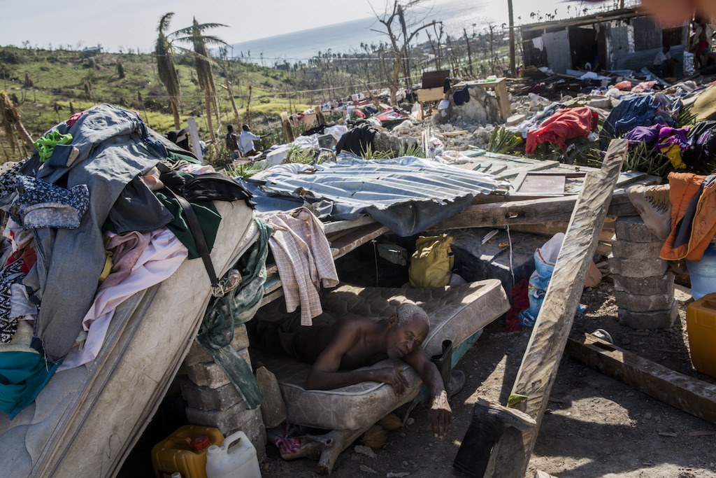 A man who is too ill to walk rests in a makeshift shelter on the site of his destroyed home, in Roche-a-Bateau suffered widespread destruction with many homes destroyed, in southwestern Haiti. Hurricane Matthew through the Caribbean on October 4 and devastated large parts of the island. Photographer: Andrew McConnell/Panos Pictures
