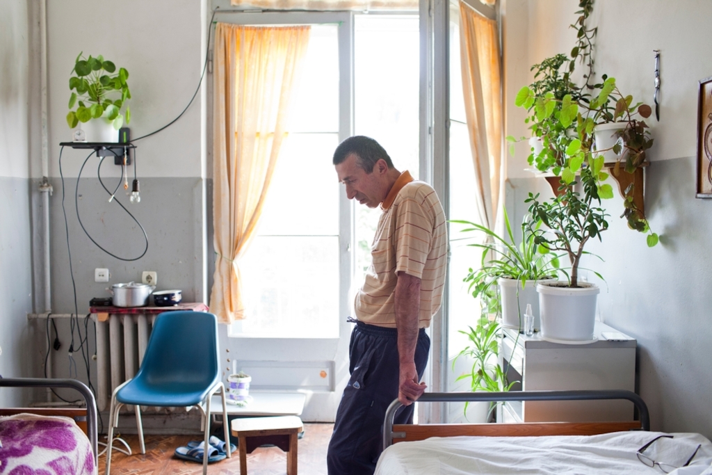 Kale Mantkava rests in his room in the tuberculosis hospital in Abastumani, a spa town in Georgia's mountainous Meskheti region. The sanatorium was built in the 1920s and continues to serve its original purpose to this day, though only 70 of its 200-or-so rooms are in a good enough state to house patients. MSF has worked here since 2014. Photographer: Daro Sulakauri/MSF