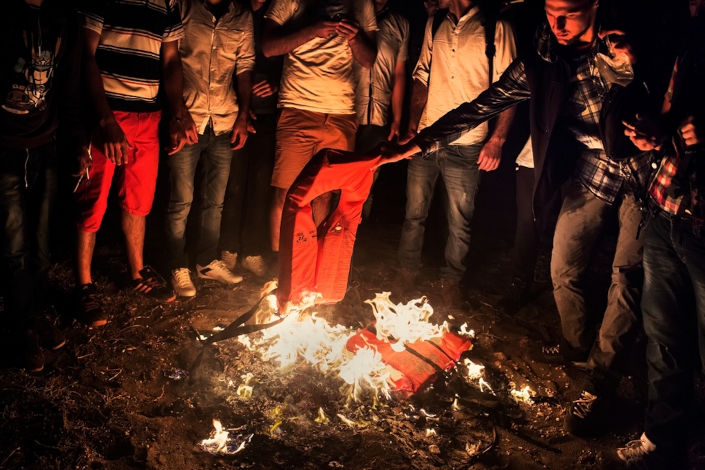Photographer: Alessandro Penso<br/><br/>Caption: Syrians who have just landed on the Greek island of Kos burn their life jackets for warmth and also to attract the attention of the police. This group of Syrians arrived on relatively remote and inaccessible part of the island at night and not knowing what to do, they light the fire to attract the attention of the coast guard.