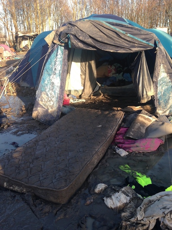 Photographer: Vickie Hawkins<br/><br/>Caption: Refugees in the Gramde Synthe refugee camp near Dunkirk, France, contend with deplorably bad conditons in the camp with mud, flooding and a lack of sanitation. Authorities have imposed a ban on humanitarian agencies bring in any building materials or any extra comfort items such as blankets despite the desperate conditions and deteriorating health of the inhabitants.