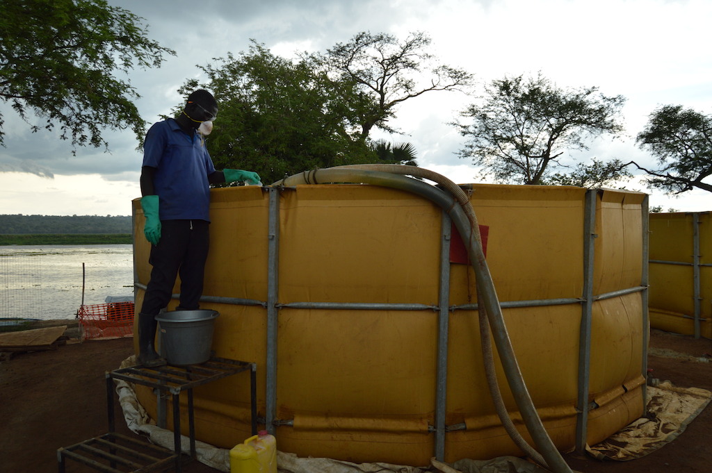 An MSF staff member adds chemicals to purify water at MSF’s water treatment plant in Palorinya refugee settlement, northern Uganda. MSF produces an average of 2 million litres per day from the Albert Nile River, which is delivered to tanks throughout the settlements by water trucks rented by UNHCR. Bad road conditions make it difficult for trucks to access all areas of the settlements after heavy rains, leaving several areas vulnerable to water shortages. <br/>By 5 May 2017, there were over 901,755 South Sudanese refugees in Uganda, with the number expected to rise to nearly one million by the end of the year. Some 86% of the South Sudanese refugees in Uganda are women and children under 18, and an average 2,000 new refugees arrive each week. Uganda is now the largest hosting country for South Sudanese refugees, and also the country hosting the largest population of refugees in Africa. Photographer: Yuna Cho/MSF