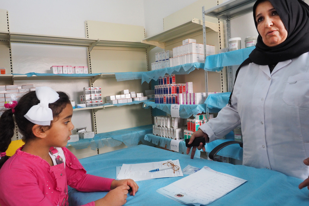 Zuwara, April 19, 2016. In the polyclinic Jedi Ibrahim, located in the old town. Rahaf, 5, during a visit in the paediatric service of Jedi Ibrahim clinic with her mother. Here in the pahamacy, with Tmomin, pharmacist. Photographer: Samuel Gratacap