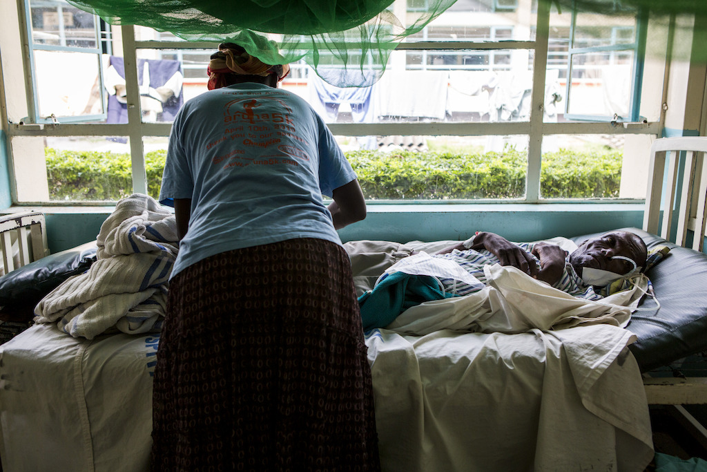 Homa Bay, Kenya: Moses, 46 years, has AIDS and cerebral palsy and requires nasogastric nutrition support as he cannot eat. He has been put on second line antiretrovirals and is being supported by his wife in Homa Bay hospital. <br/><br/>Each AIDS patient represents a tangled web of individual, community, cost and health system weaknesses that have prevented or interrupted effective lifelong HIV treatment. Photographer: Patrick Meinhardt
