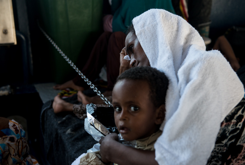 Credit: Gabriele François Casini / MSF<br/>Caption: Phoenix rescue 02 Sept 2015. A woman from Eritrea cries while holding her baby on the Phoenix’s lower deck. The journey people go through both on land and at sea is extremely traumatizing.