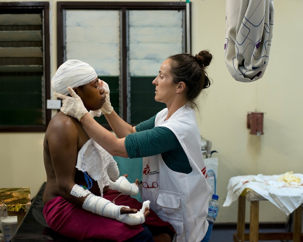 A woman receives medical care at MSF's family and sexual violence clinic in Tari hospital, Hela province, in the highlands region of Papua New Guinea. She sought treatment for lacerations after her husband cut her with a knife on the back of her head and both hands. Photographers: Jodi Bieber