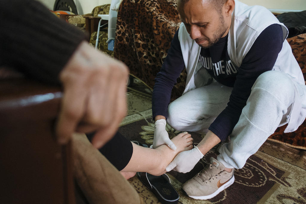 In the Burj el-Barajneh Palestinian camp to the south of Beirut, an MSF team provides home-based care to almost 170 elderly and bed-ridden patients living with chronic diseases. The service brings not only medical benefits for the patients, but often also allows a brief moment of human warmth in otherwise very lonely lives. “When they visit me I feel better. They visit me two or three times a week. I tell them that I’m out of my medication and they get it for me,” says Amina Banat. Photographer: Bruno De Cock