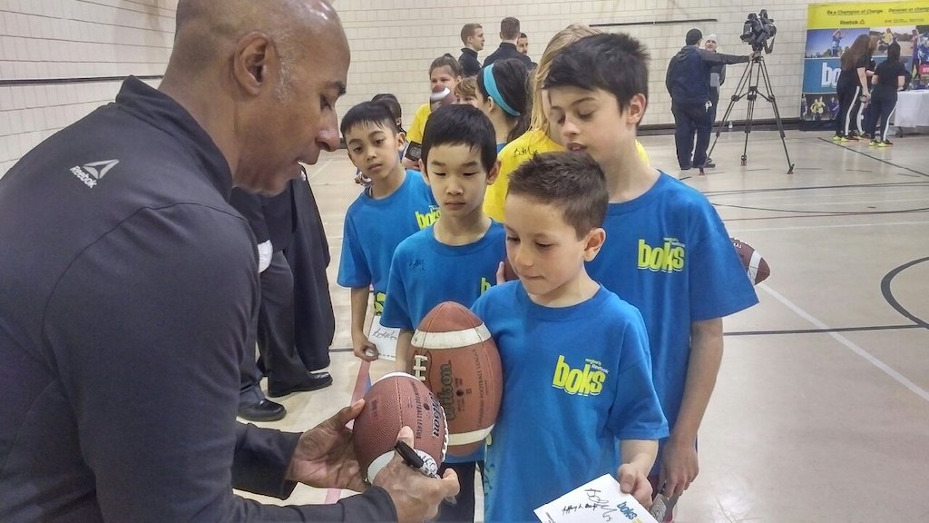 Commissioner Jeffrey Orridge signing autographs for kids at Ecole Centennial Community School