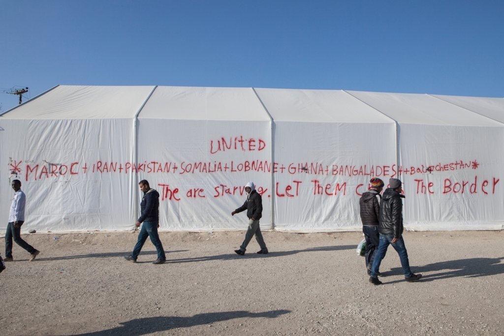 Photographer: Alex Yallop<br/><br/>Caption: Graffiti sprayed onto a tent in support of the several thousand people have been stranded in at the Greek/Macedonia border unable to cross due to nationality restrictions put in place by several Balkan nations. At a makeshift refugee camp in Idomeni, Greece near the border with Macedonia.