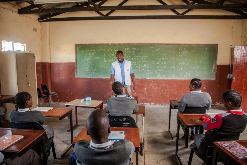 Doctors Without Borders (MSF) Lay Counsellor Nkosinathi Mpungose delivers a HIV health talk to learners of Hhashi High School in ward 1 of Uthungulu District, Umlalzi Municipality Eshowe. The learners will be given the opportunity to sign up for HIV testing at the Mobile 1-Stop Shop (M1SS) parked on the school grounds. MSF’s Mobile 1-Stop Shop has travelled to dozens of schools, colleges and local sporting and cultural events to deliver HIV Counselling and Testing to people of all ages in rural KwaZulu-Natal, the South African province with the highest prevalence of HIV infection. Photographer: Greg Lomas / Médecins Sans Frontières