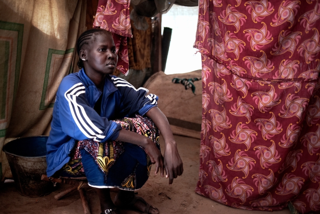 MSF159879<br/>Portrait of Calle in a displaced persons camp.<br/><br/>Calle her mother Martine, and daughter, Divine are from Bossangoa. They fled after the attack on their home by an armed group who burned all their belongings and killed both Martine’s parents and Calle’s husband. They travelled for three weeks to find refuge in Bangui. They don’t have jobs and to find food is a daily struggle. Those they share the shelter with help them to find food but it is not enough. Divine is not going to school because they cannot find the money for the registration. They want to return to Bossangoa but cannot do so because the trip costs too much. "At night, it is cold in our shelters. We don’t have any blankets. "