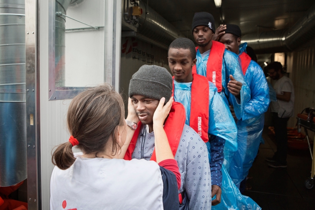 Photographer: Alessandro Penso<br/><br/>Caption: Irene a medical coordinator with Doctors Without Borders (MSF) says goodbye to refugees and migrants as they disembark the Bourbon Argos and are transferred to a Norwegian vessel.