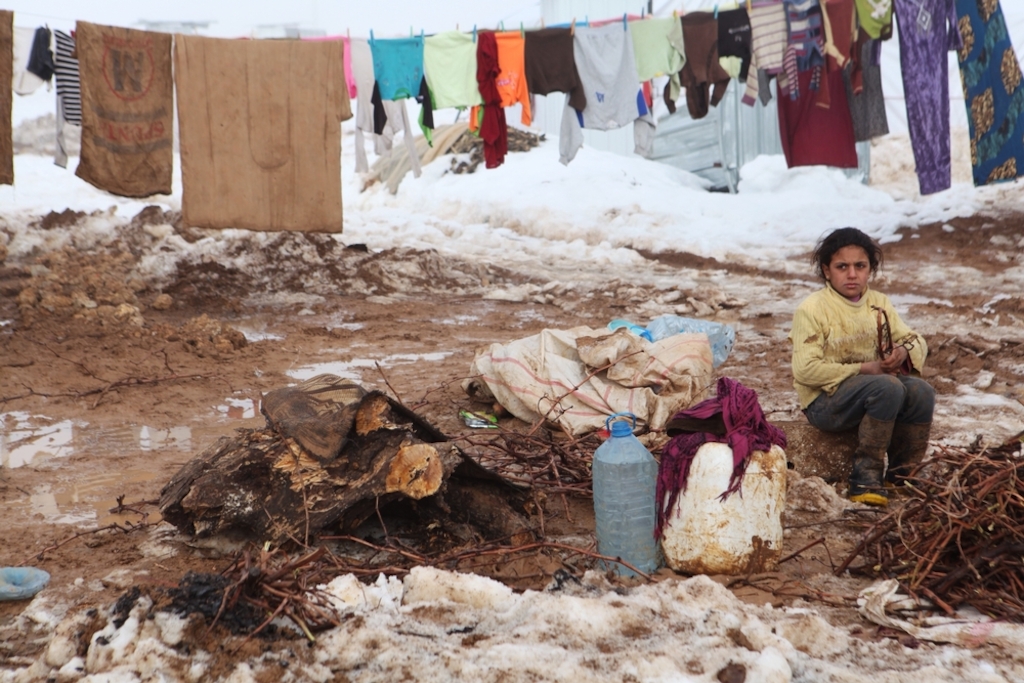 System identifier<br/>: MSB16994<br/>Title<br/>: Harsh winter conditions for refugees in Lebanon<br/>Photographer / cameraman<br/>: Ghazal Sotoudeh<br/>Countries:<br/>Lebanon<br/>Description<br/>: A child sorts through firewood amongst washing lines as freezing fog surrounds the<br/>Khoder Hawash makeshift settlement for refugees on the outskirts of Baalbek in Lebanon's Bekaa<br/>valley 17 January 2014. <br/>Snow and hail fell heavily 07 January in Lebanon’s Bekaa valley, where some 400,000 Syrian<br/>refugees are sheltering in a number of makeshift camps