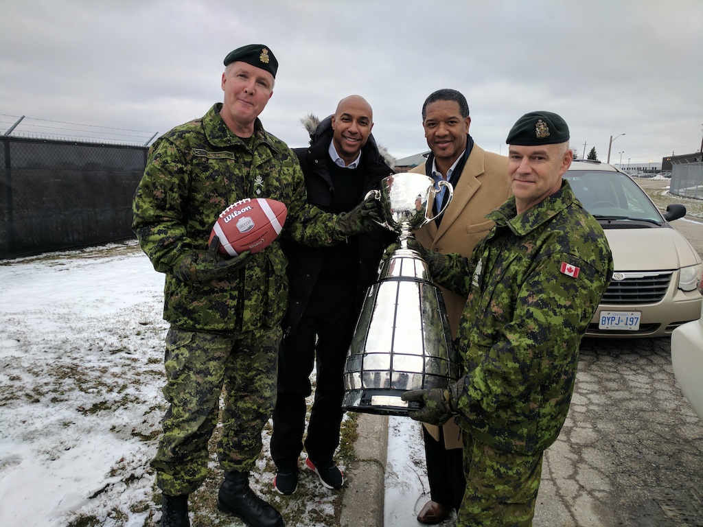 Commissioner Jeffrey L. Orridge with the Grey Cup and members of the Canadian Armed Forces