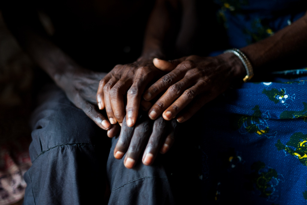 Kinshasa, DRC: Jean-Pierre Lingombe suffers from AIDS and Tuberculosis. He was hospitalised at MSF’s HIV-AIDS hospital in Kinshasa and treated for HIV and AIDS. That is where he met Marie, a former patient at the MSF HIV-AIDS hospital who later provided palliative care there to AIDS patients. Jean-Pierre and Marie now live together in a small house just outside the city of Kinshasa. Jean-Pierre is now followed by the Roi Baudouin Hospital in Kinshasa for his tuberculosis treatment. However, at the time of the visit of the photographer, he had not received his TB drugs because of a drug stockout at the hospital. Credit: Peter Caesar