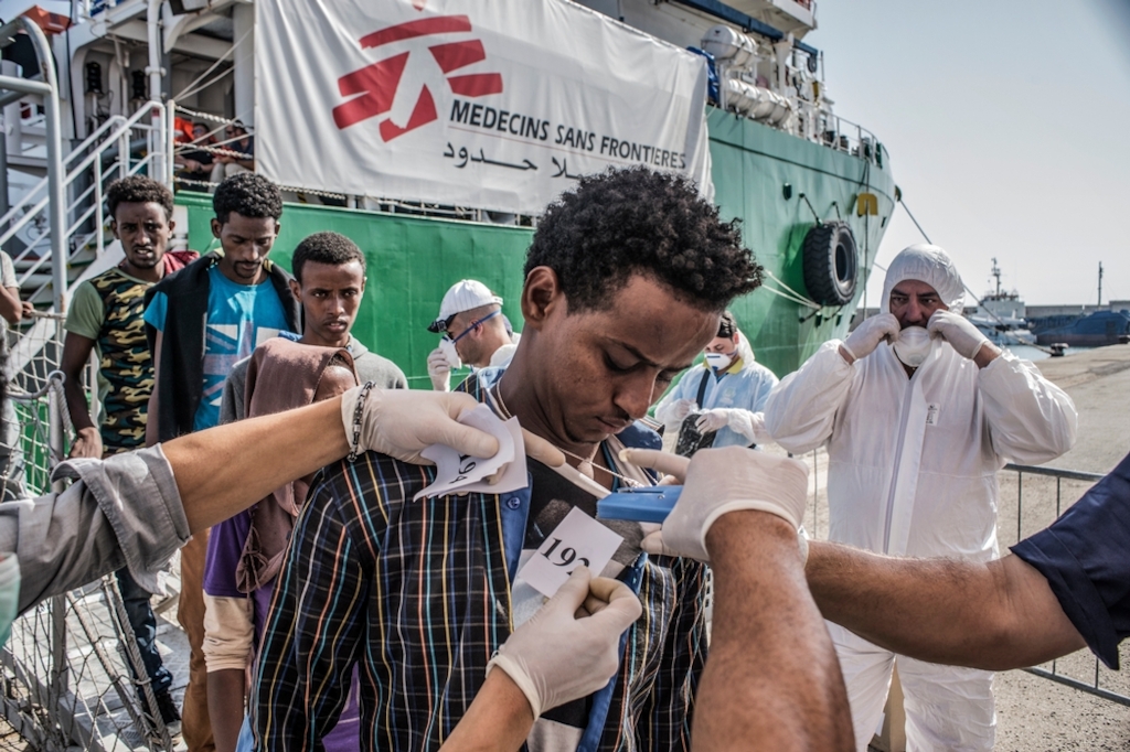 Photographer: Francesco Zizola<br/><br/>Caption: A refugee is numbered by the Italian authorities as people disembark the Bourbon Argos in Vibo Valentina, Calabria, Italy and queue to be registered.