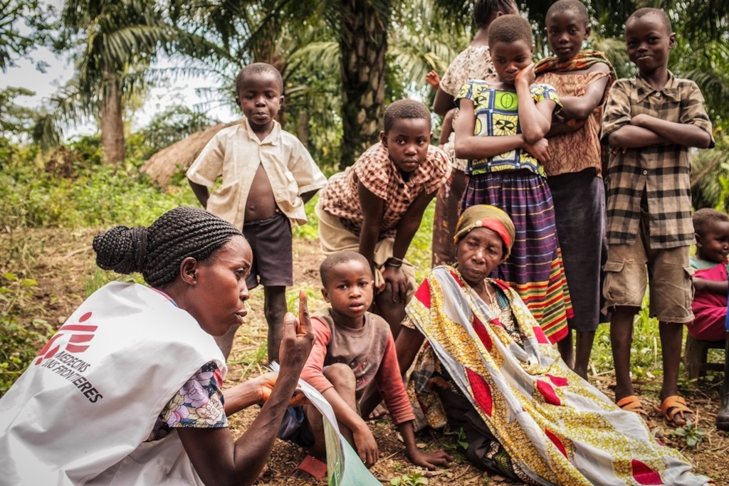 An MSF health promoter talks to children and parents in the village of Rubingo, during a community healthcare and health promotion programme in Boga, Democratic Republic of Congo. Photographer: Gabrielle Klein/MSF