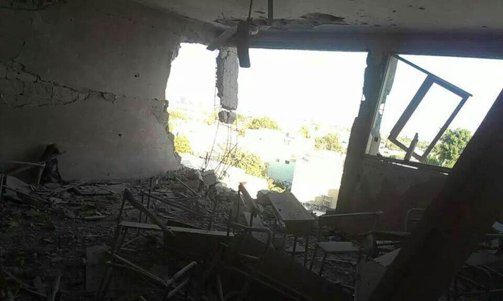 Bomb damage to the upper floors of the abandoned school building used as a makeshift hospital in a beseiged neighbourhood of east Damascus. Photographer: MSF