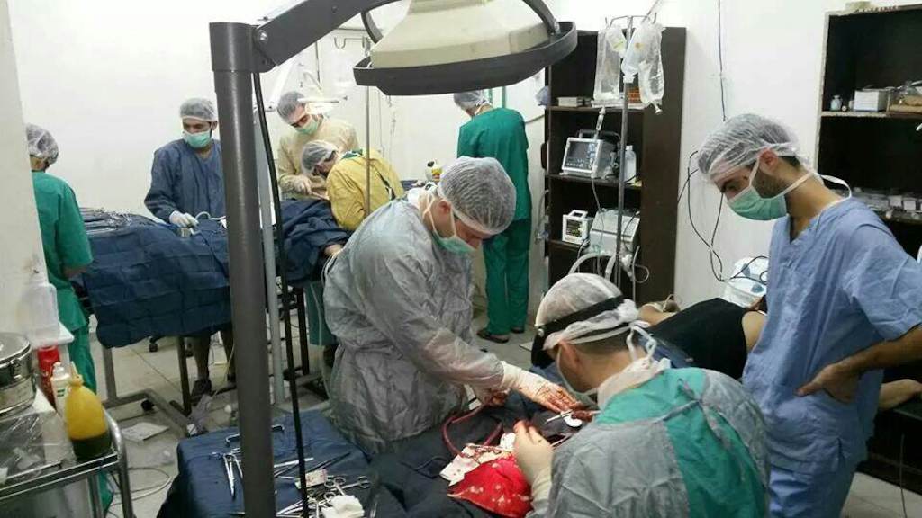 Doctors and surgeons treat the wounded in a operating theatre set up in a makeshift hospital in an east Damascus neighbourhood.<br/>Photographer: MSF