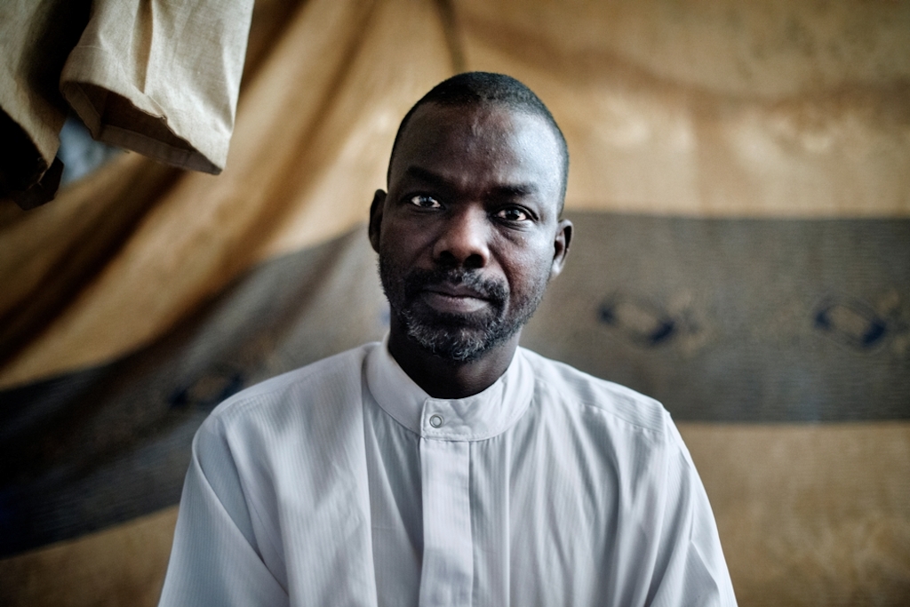 MSF159649<br/>Portrait of 37 year old Amin at a displaced persons camp at the Central Mosque in Bangui.<br/><br/>Amin is a former diamond merchant and artisan. Since December 5, 2013, he has had no work. He fled when an armed group surrounded his house and shot indiscriminately. He was able to be safe by staying hidden with his family (his wife and two children, 15 and 5 years). Then they joined relatives who welcomed them for 3 weeks. Amin and his family then fled to the central mosque. Today Amin is surviving thanks to the solidarity of his neighbors. His two children are able to go to school. Amin does not wish to return to Boirab because security is not guaranteed. <br/><br/>If the presidential election improves the situation, Amin plans to stay in the mosque but if the situation does not change, he will go with his family to the North. According Amin, since the Pope's visit, the situation seems to have improved but fear remains present.