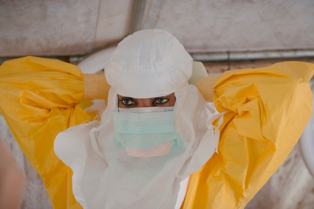 System identifier: MSB17721<br/>Title:<br/>Photographer / cameraman: Yann Libessart<br/>Countries: Guinea<br/>Description: MSF staff dressing in PPE to enter the high risk zone at MSF ETC in Donka, Conakry.