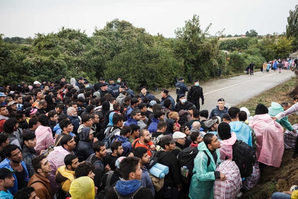 Photographer: Achilleas Zavallis<br/><br/>Caption: Refugees and migrants wait on the Serbian side of the Bapska border crossing hoping to enter Croatia.