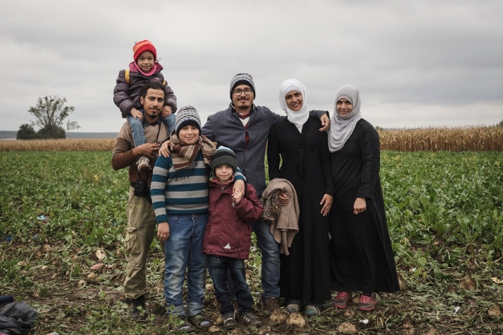 Photographer: Achilleas Zavallis<br/><br/>Caption: Portrait of an extended family from Idleb, Syria (left to right)<br/>Leen (4) sits on the shoulders of her uncle Obaida (31), Abdullah (14), Wallied (5), Mohammed (29), Bayan (18), Suha (32), while they wait on the Serbian side of the Sid - Tovarnik border crossing to enter Croatia.