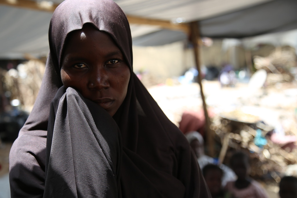 A Nigerian woman stands in the compound where MSF runs a hospital in the northeastern town of Pulka and where several hundred displaced people seek refuge. Photographer: Igor Barbero