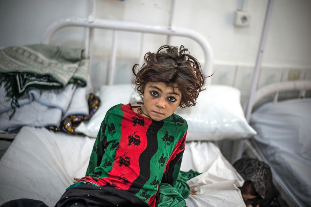 A girl waits in the emergency room of Boost hospital, Lashkar Gah, in Afghanistan's Helmand province, which MSF runs alongside the Afghan Ministry of Health. Photographer: Kadir Van Lohuizen/Noor