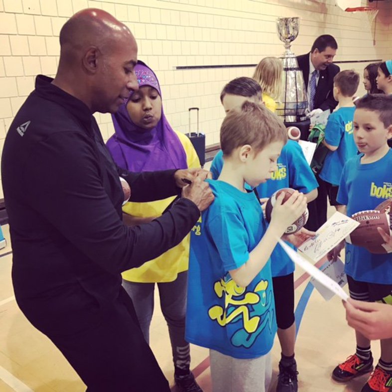 Commissioner Jeffrey L. Orridge signing autographs at Ecole Centennial Community School