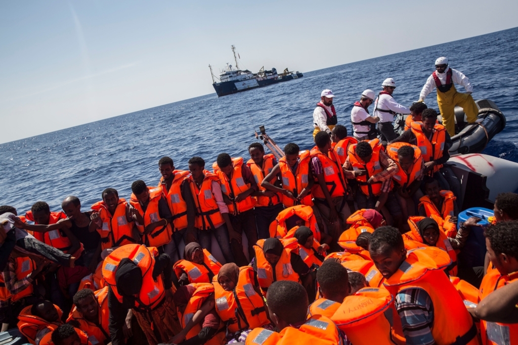 Photographer: Anna Surinyach<br/><br/>Caption: The Dignity I team conduct a rescue of people from a large, overcrowded, inflatable boat 02 September 2015, in the Mediterranean sea.