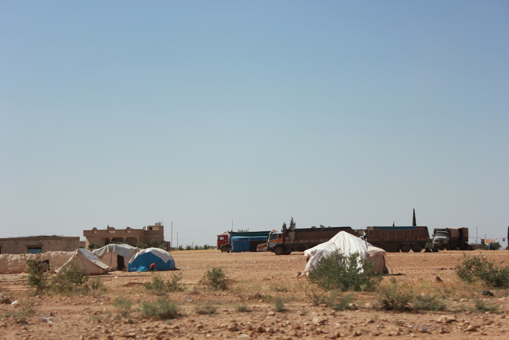 Tenten staan overall rond nabij Menbij in Noord-Syrië. Families proberen een plekje te veroveren in afwachting tot de situatie weer beter wordt