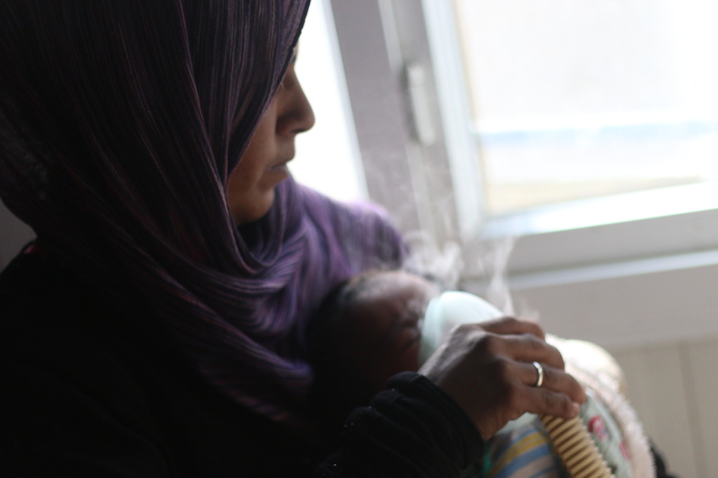 A mother gives her baby treatment on a nebulizer in this picture taken in MSF’s hospital on March 18th in Azaz district in Aleppo governorate, northern Syria. On April 18th MSF warned that the situation was critical for more than 100,000 people who were trapped by renewed fighting in the area, and called on all warring parties to respect civilians and health structures. Photographer: Mahmoud Abdel-rahman