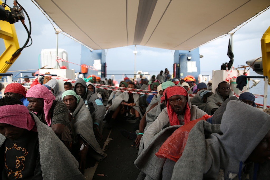 Rescued people preparing to disembark in Italy on 5 October. Many of the people who risk their lives through the Central Mediterranean route also have a nightmarish stop in Libya where, according to interviews with hundreds of people conducted by our medical teams, many suffer detention, sexual violence and torture. Photographer: Mohammad Ghannam