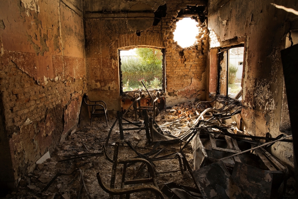 System identifier<br/>: MSF154407<br/>Title<br/>: Kunduz Hospital Aftermath - 14 Oct 2015<br/>Photographer / cameraman<br/>: Victor J. Blue<br/>Countries:<br/>Afghanistan Description:An interior view of the MSF Trauma Centre, 14 October 2015, shows a missile hole in the wall and the burnt-out remians of the the building aftera sustained attack on the facility in Kunduz, northern Afghanistan.