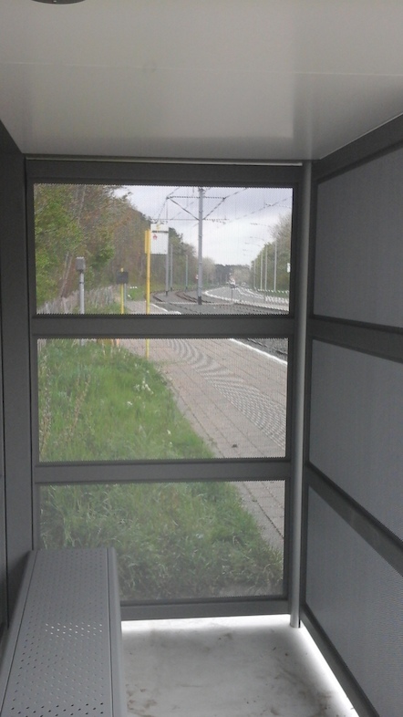De stalen wanden van het vandalismebestendig schuilhuisje zijn doorzichtig dankzij perforaties van 4 cm. (Foto: De Lijn)