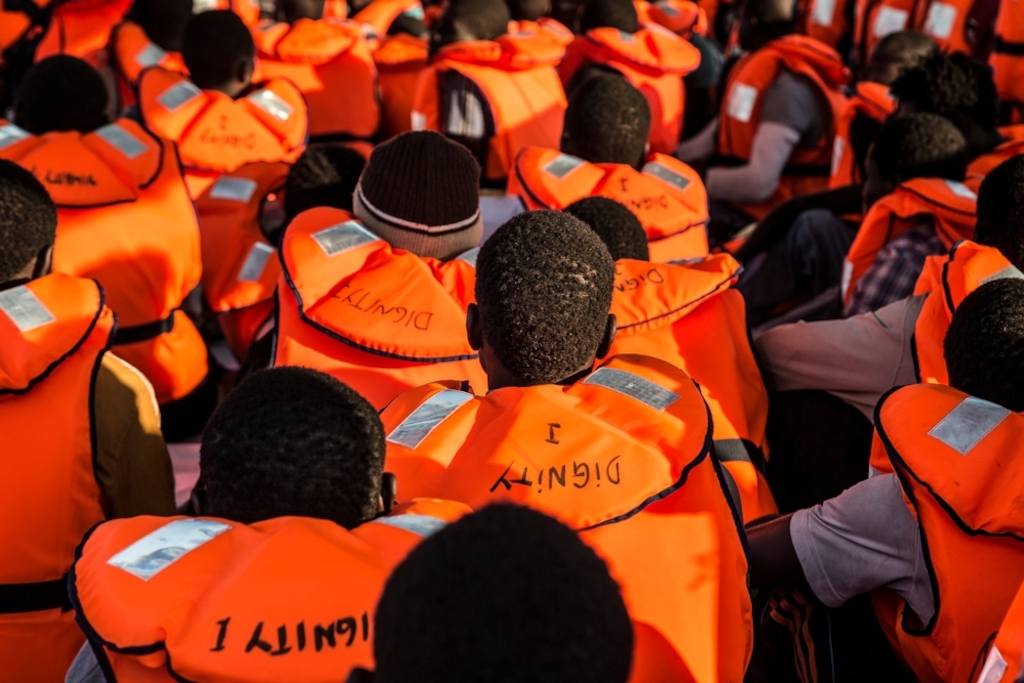 Photographer: Anna Surinyach<br/><br/>Caption: 87 people, mainly from Senegal and Gambia rescued by the Dignity I, wait on the deck to be transferred to an Italian vessel that will take them to Sicily.
