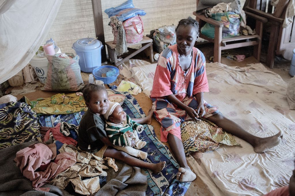 Nadège is the mother of three children, two daughters, Gabriella and Abigaille, and a boy born one month ago, named Prosper. Nadège gave birth in BenZvi camp helped by a traditional midwife.<br/><br/>Ethna (see MSF159672) and Nadège are friends and used to live in the same neighbourhood. When violence broke out in December 2013, they decided to flee their home district in KM5 in Bangui.<br/><br/>Armed groups killed Ethna's grandfather and looted her whole house. Following the attack, she fled at first to the Saint Jacques camp but there was not enough space in the church, so they decided to flee again to Benzvi camp. She has been living in this camp for almost two years now.<br/><br/>The two women are unmarried and to survive, they sell cakes on the street. "We eat only once a day."<br/><br/>Since they moved in to the camp, Ethna and Nadège’s children have fallen ill with malaria several times, but have received treatment by Medecins Sans Frontiers (MSF’s) mobile clinic.<br/><br/>Sometimes, they try to return to their home area to see if they can go back there but it still very insecure.