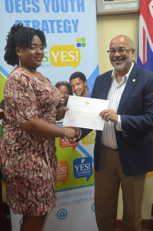Dr. Jules presents certificate to graduate