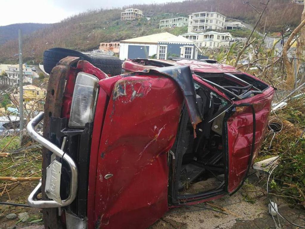 A damaged vehicle flipped on its side in the aftermath of Hurricane Irma © AP