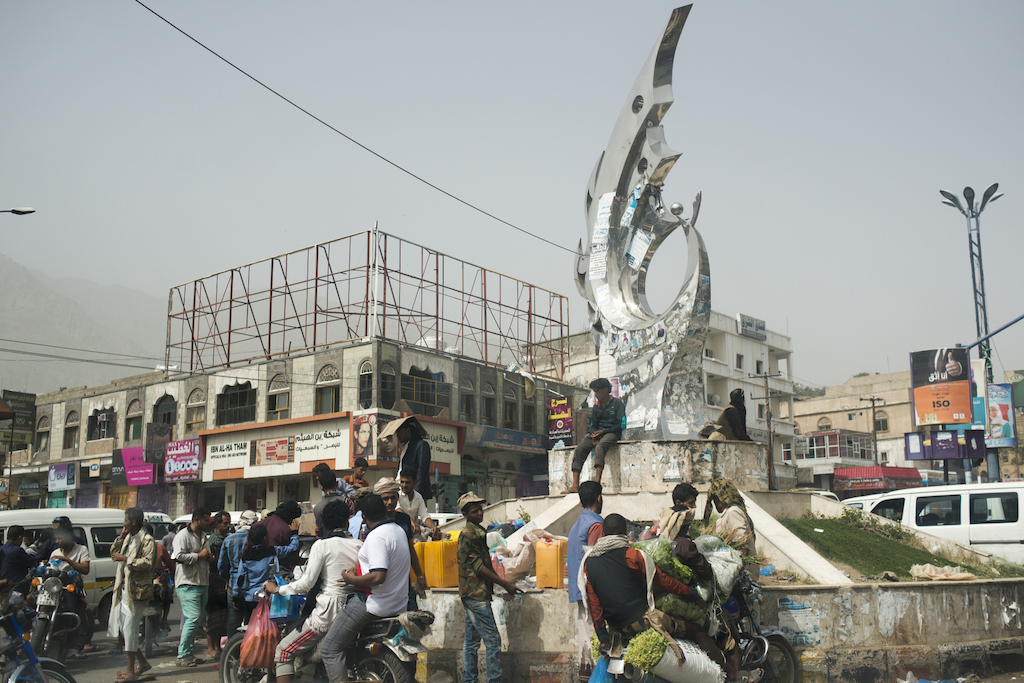 Yemeni men and boys buy and sell petrol on the black market on July 25, 2015 in Taiz, Yemen. With a severe petrol shortage, small bottles can go for three times the normal price. Photographer: MSF