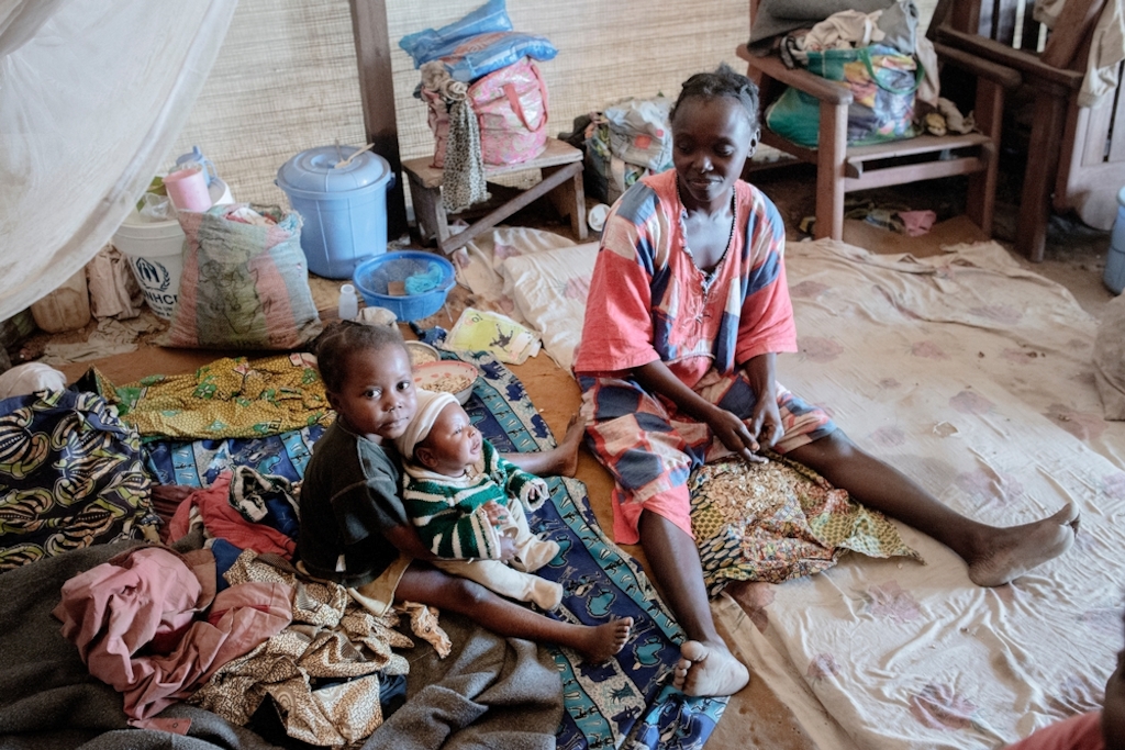 MSF159633<br/>Nadège is the mother of three children, two daughters, Gabriella and Abigaille, and a boy born one month ago, named Prosper. Nadège gave birth in BenZvi camp helped by a traditional midwife.<br/><br/>Ethna (see MSF159672) and Nadège are friends and used to live in the same neighbourhood. When violence broke out in December 2013, they decided to flee their home district in KM5 in Bangui.<br/><br/>Armed groups killed Ethna's grandfather and looted her whole house. Following the attack, she fled at first to the Saint Jacques camp but there was not enough space in the church, so they decided to flee again to Benzvi camp. She has been living in this camp for almost two years now. <br/><br/>The two women are unmarried and to survive, they sell cakes on the street. "We eat only once a day." <br/><br/>Since they moved in to the camp, Ethna and Nadège’s children have fallen ill with malaria several times, but have received treatment by Medecins Sans Frontiers (MSF’s) mobile clinic.<br/><br/>Sometimes, they try to return to their home area to see if they can go back there but it still very insecure.