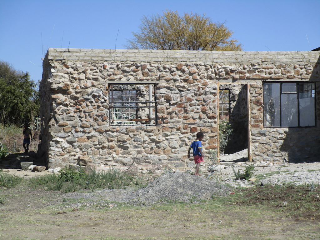 34. These children say they go into this unfinished building with other boys and girls when their parents are not watching: “We play ‘house’, and do what our parents do at our house: we play husband and wife, cook, sit and watch TV, go to bed with our wives, and wake up and clean our ‘house’.” Photographer: Mitchelle Motswari